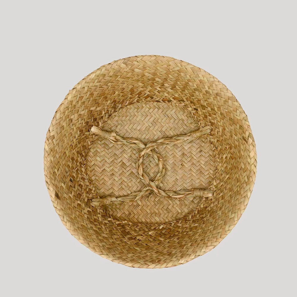 Beige rattan basket with white and green hand-knotted tassels – close-up detail