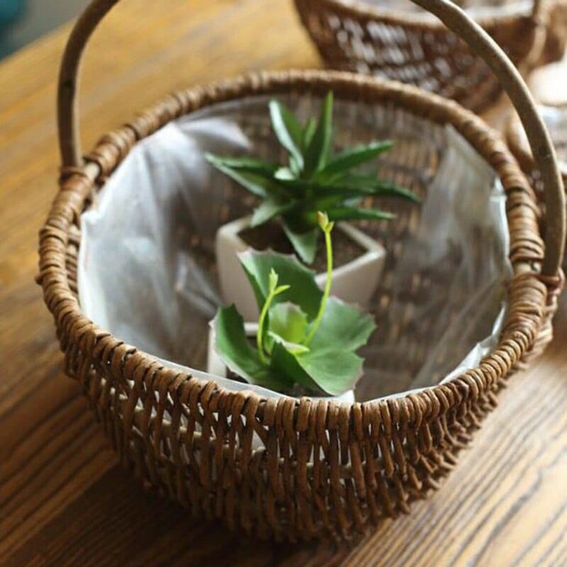 Round woven catchall basket with golden highlights – shown in a room setting (3)