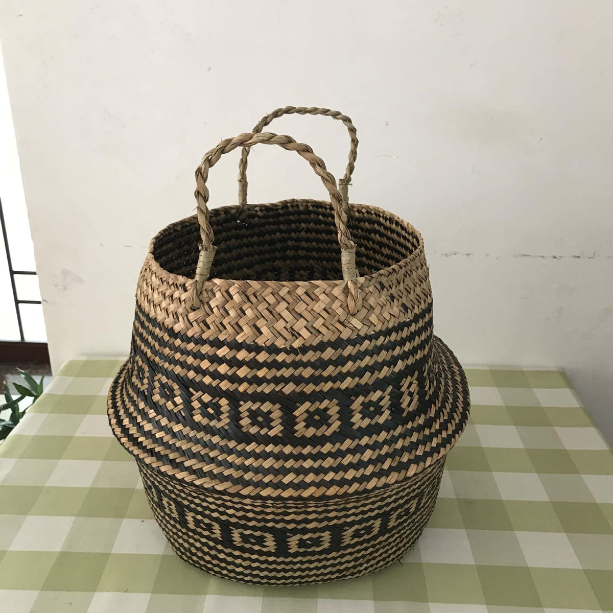 Handwoven natural rattan home basket with an even braid – shown in a room setting