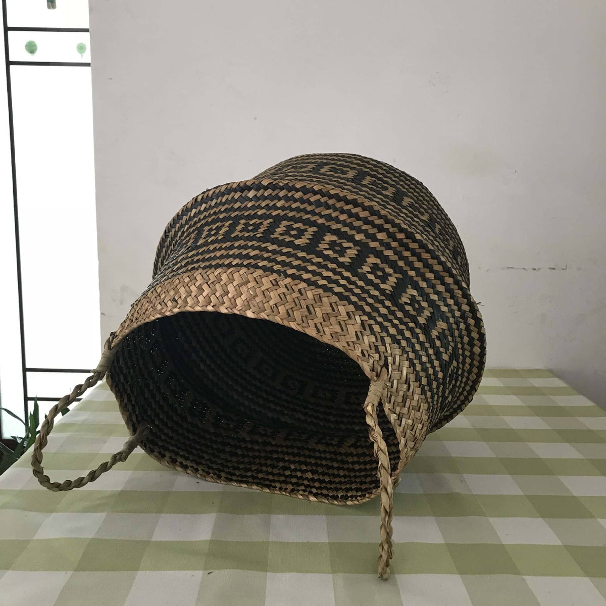 Handwoven natural rattan home basket with an even braid – shown in a room setting (2)