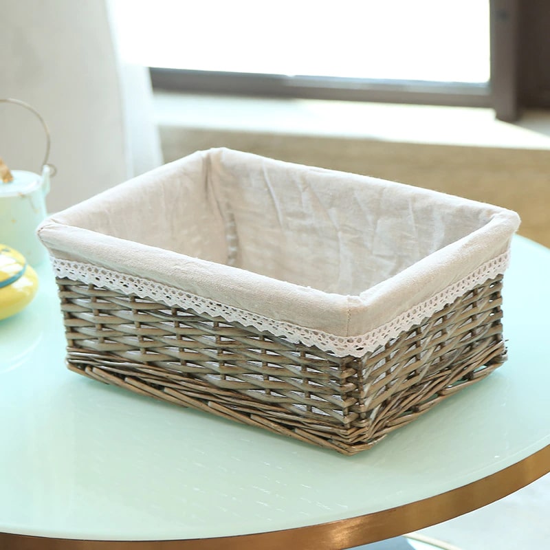 Rectangular rattan storage basket with a removable cotton liner – gray variant, shown in a room setting