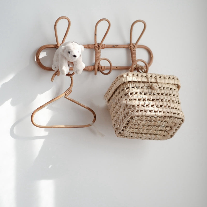 Dark rattan round wall rack with three hooks – shown in a room setting (2)