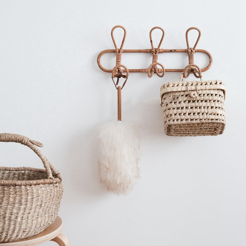 Dark rattan round wall rack with three hooks – shown in a room setting (3)