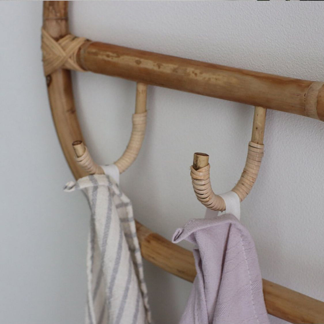 Rectangular natural rattan coat rack with three braided hooks – shown in a room setting (3)