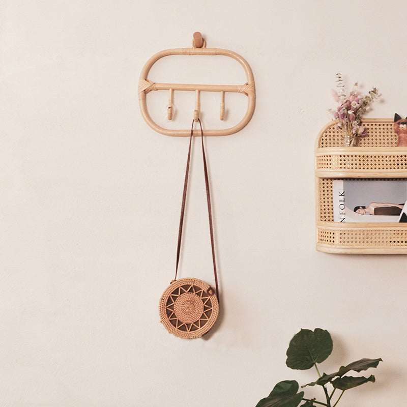 Rectangular natural rattan coat rack with three braided hooks – shown in a room setting (4)