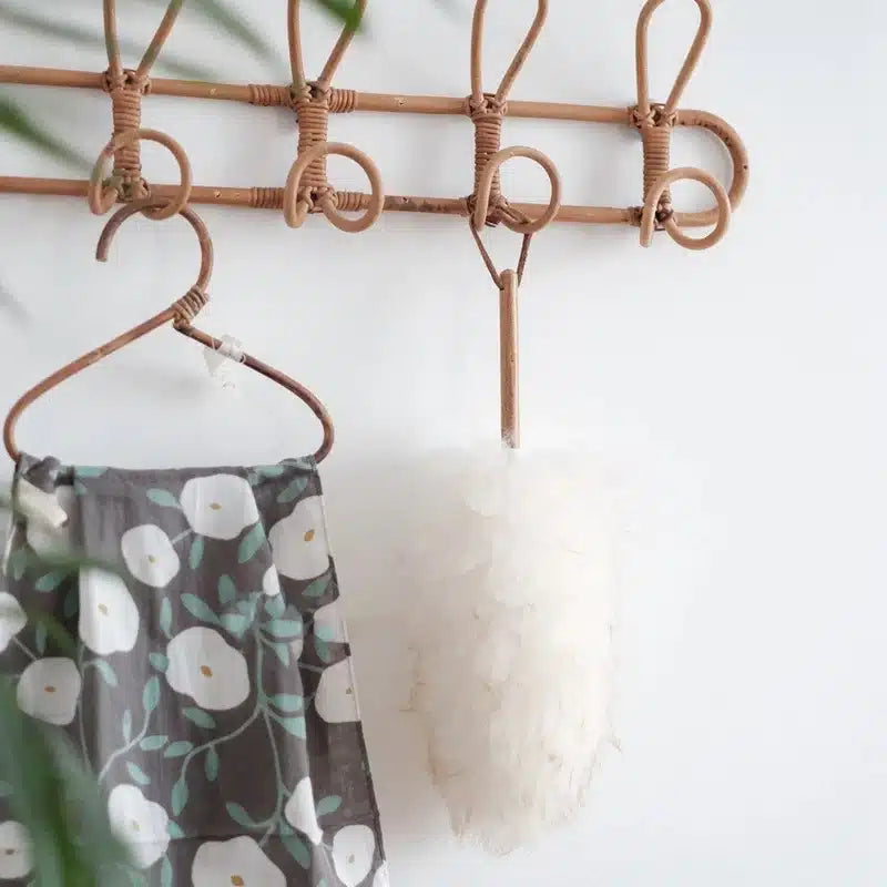 Vintage-style dark rattan coat rack with five hooks – shown in a room setting (2)