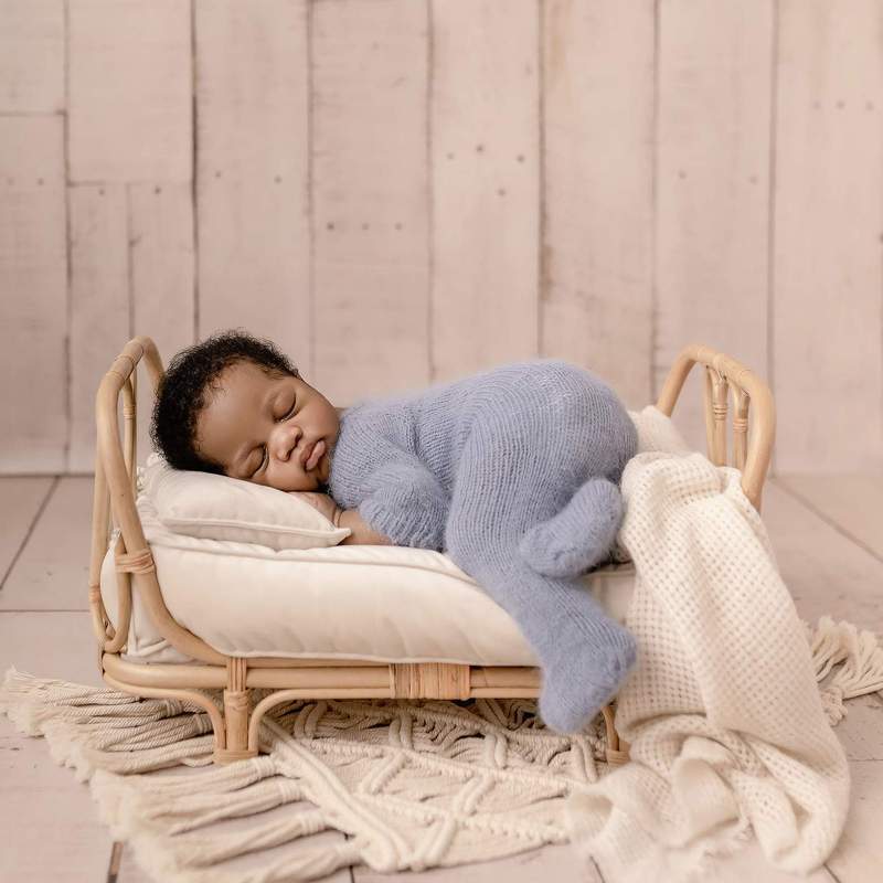Small openwork rattan baby bed – shown in use