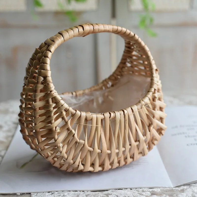 Small half-moon wicker-look basket with a braided handle