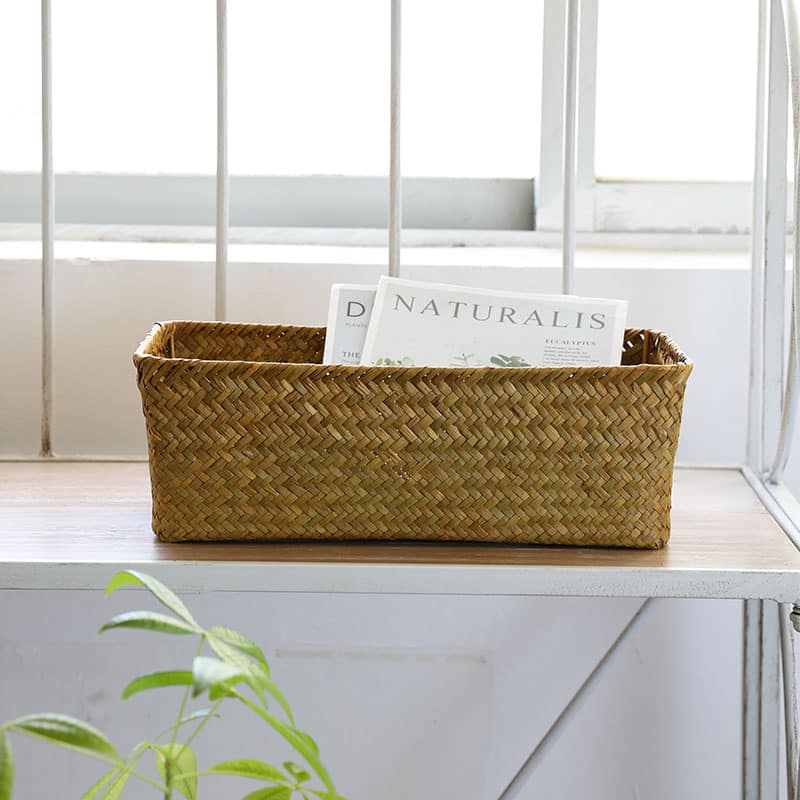 Small rectangular rattan storage basket with neatly worked edges – shown in a room setting (2)