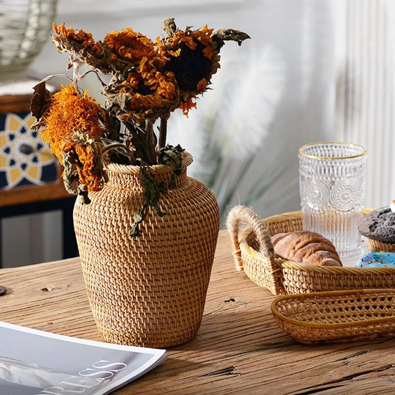 Small slender hand-braided wicker and rattan vase – shown in a room setting