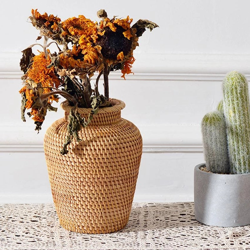 Small slender hand-braided wicker and rattan vase – shown in a room setting (2)