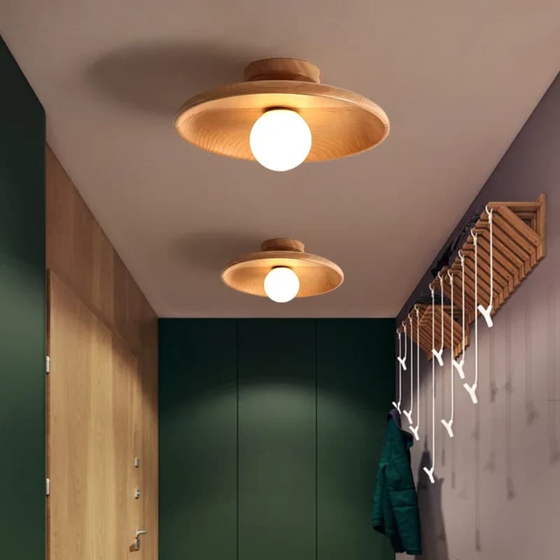 Nordic round light wood LED ceiling light with a matte finish – shown lit in a room setting (3)