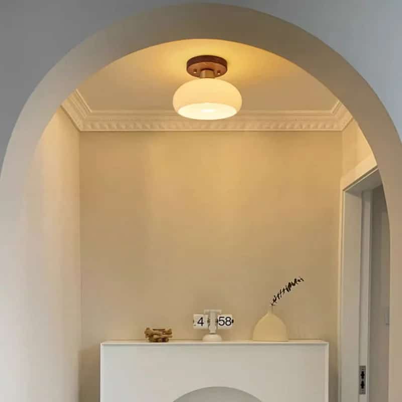 Modern wood frame LED ceiling light with translucent glass stone diffusers – shown lit in a room setting