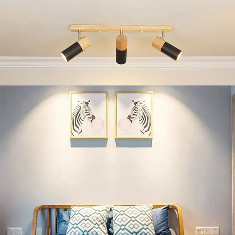 Three-head wood and metal LED ceiling spotlight – shown lit in a room setting
