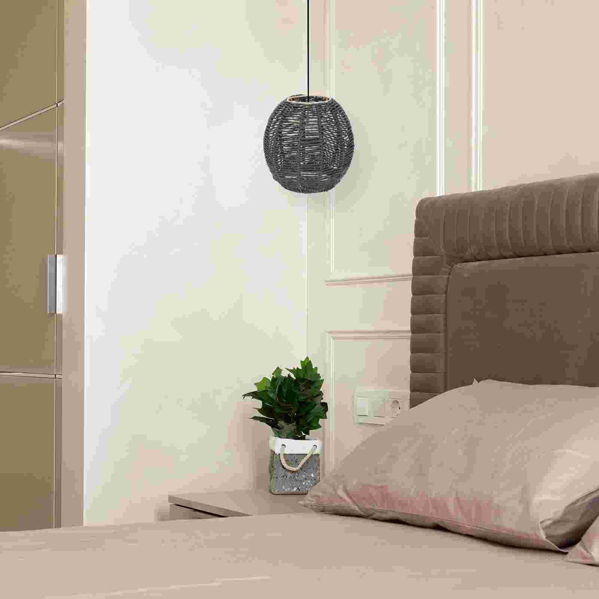 Black rattan ceiling light with a tight openwork weave – shown in a room setting