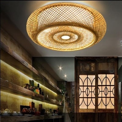 Open-weave hanging rattan ceiling light – shown lit in a room setting