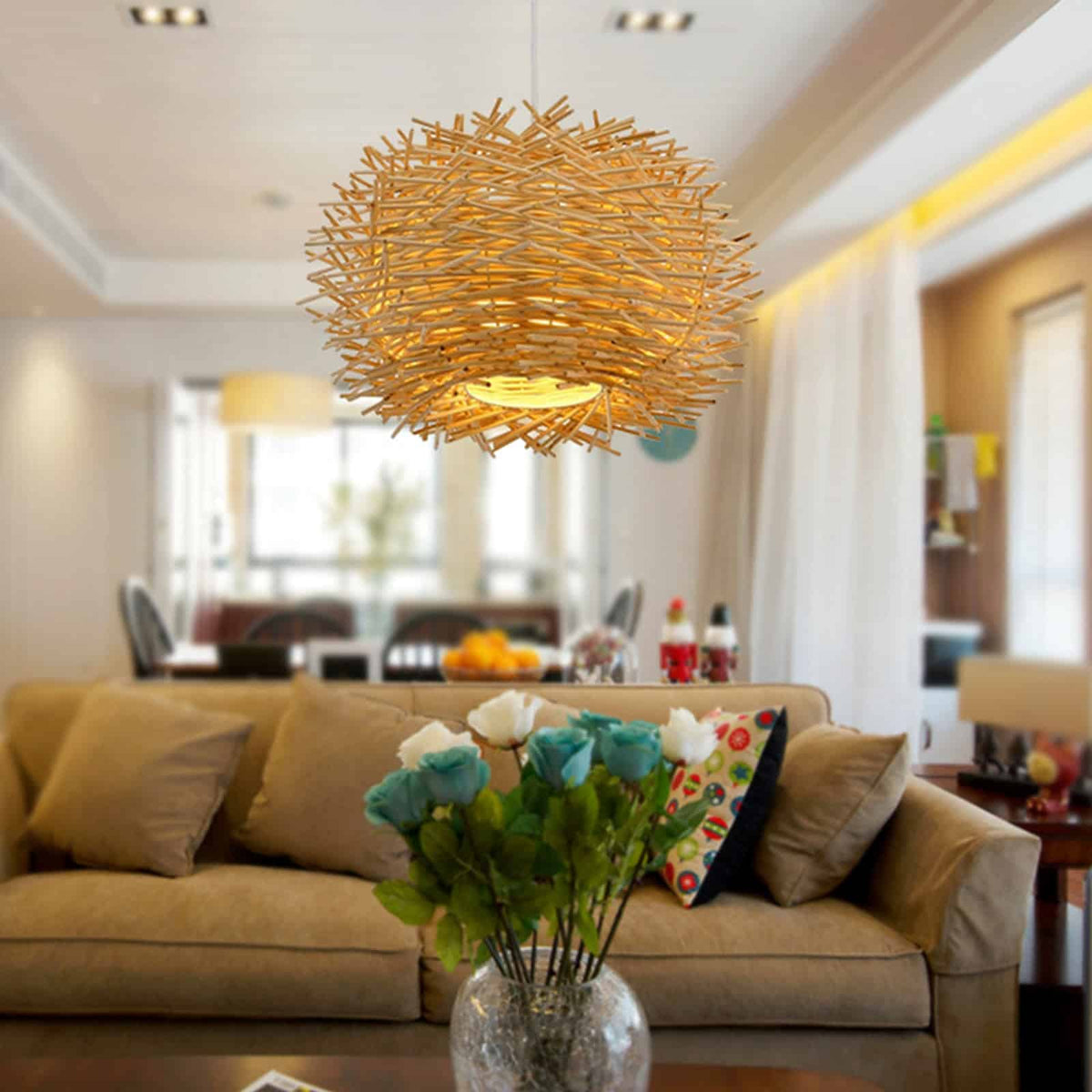 Rustic round handwoven rattan pendant light – beige variant, shown lit in a room setting