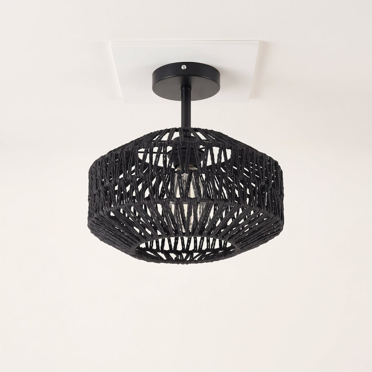 Black woven paper rope drum flush mount light on a black metal base