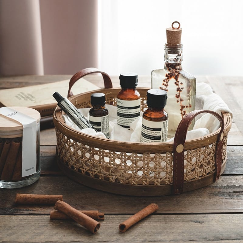 Round brown rattan tray with hand-sewn leather handles – shown in a room setting (4)