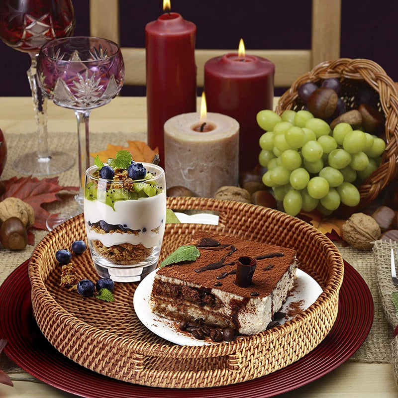 Round woven rattan serving tray with side cutout handles – shown in a room setting (2)
