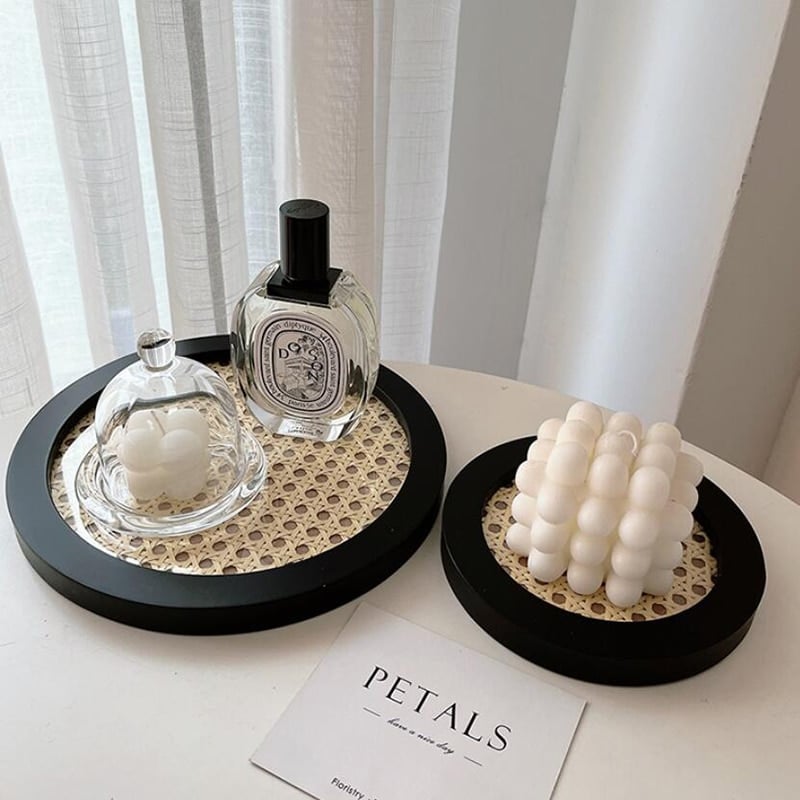 Round decorative rattan tray with a slightly raised rim – shown in a room setting