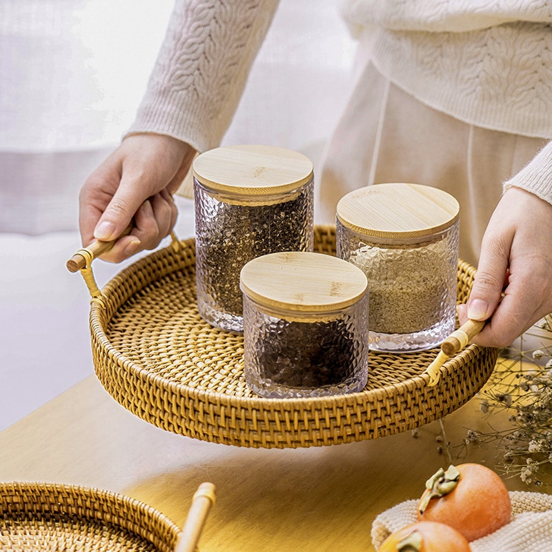 Light beige rattan serving tray with solid wood handles – shown in use