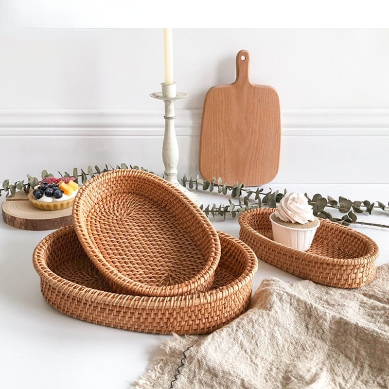 Oval genuine rattan tray with side handles – shown in a room setting