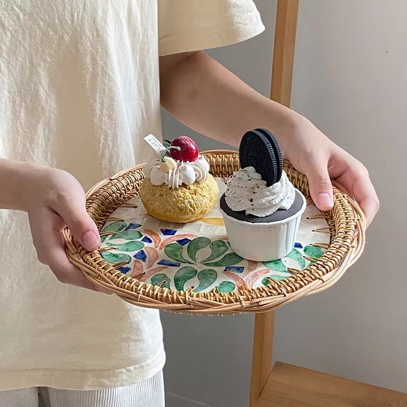 Hand-braided rattan tray with a vivid fish print – shown in use