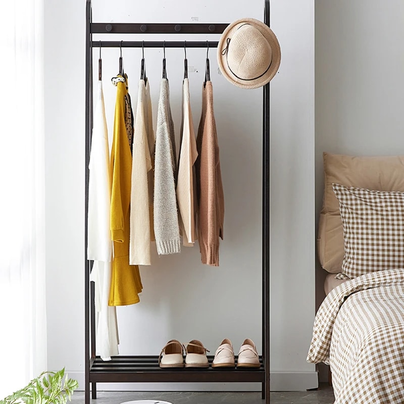 Matte black bamboo clothing rack with straight Chinese-inspired lines – shown in a room setting