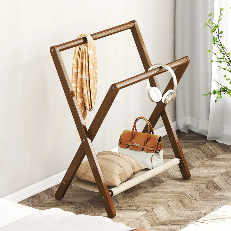 Foldable bamboo garment rack with a braided bamboo rail – shown in a room setting
