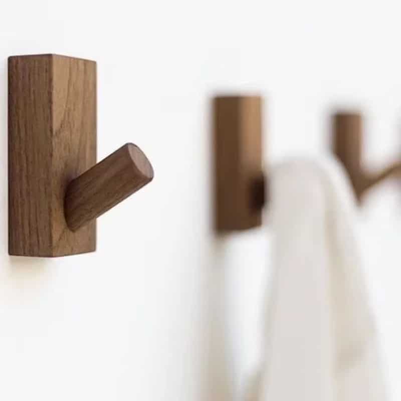 Brown wooden coat rack with visible grain – shown in a room setting