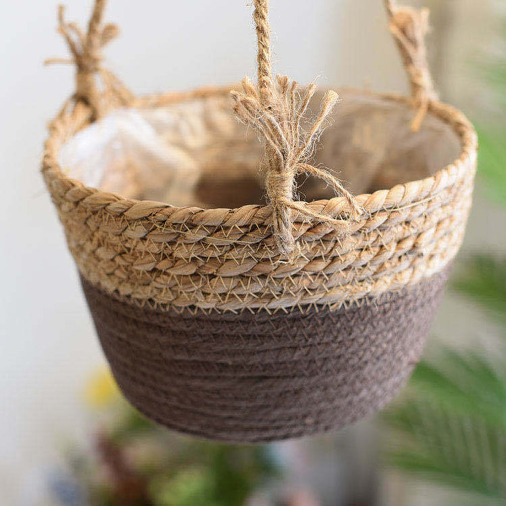 Hanging natural rattan plant holder with a round frame and fringes – shown in a room setting (2)