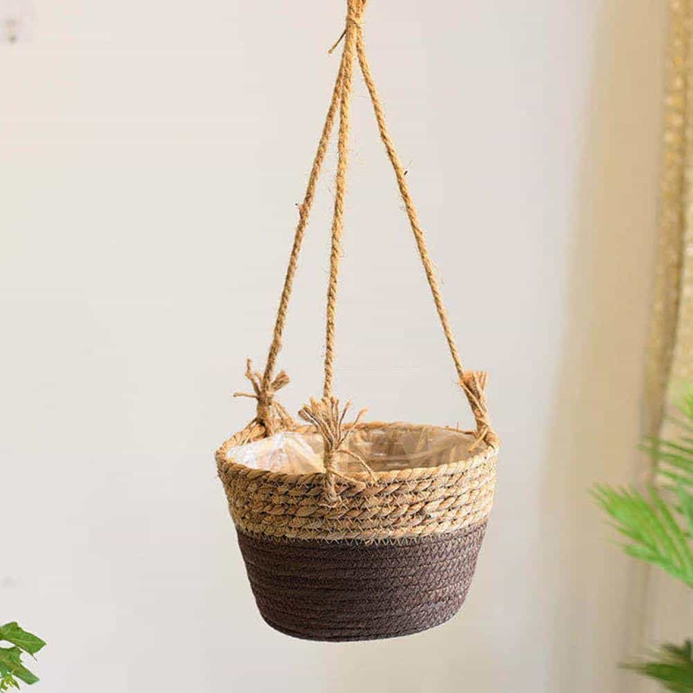 Hanging natural rattan plant holder with a round frame and fringes