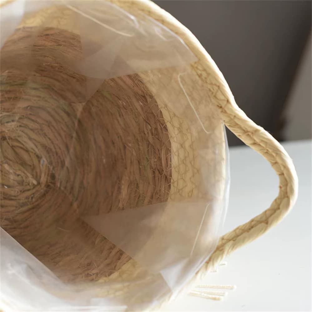 Curvy rattan planter trimmed with white tassels – close-up detail