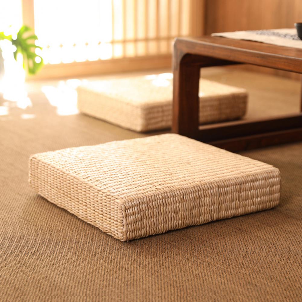 Square flat rattan pouf with a tight braid – shown in a room setting
