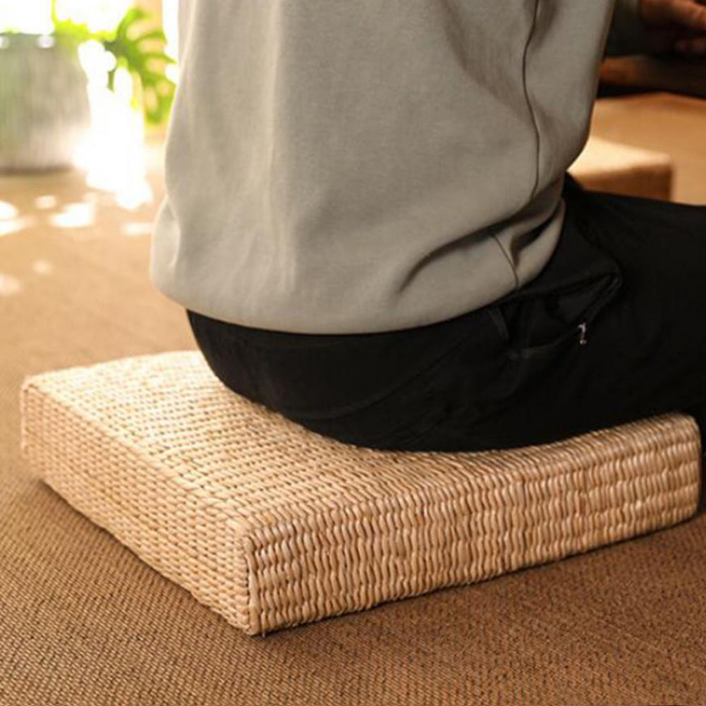 Square flat rattan pouf with a tight braid – shown in use