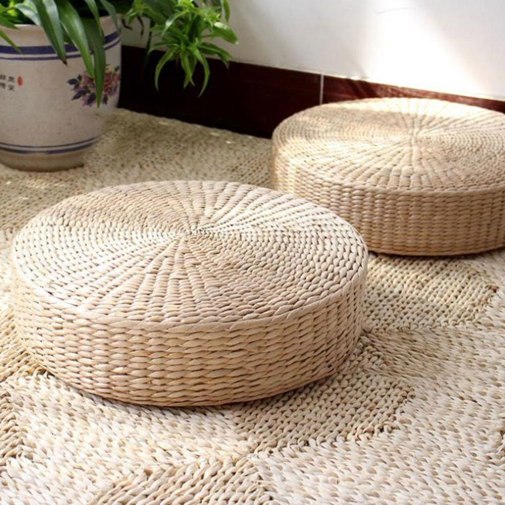 Round hand-braided natural rattan pouf – shown in a room setting