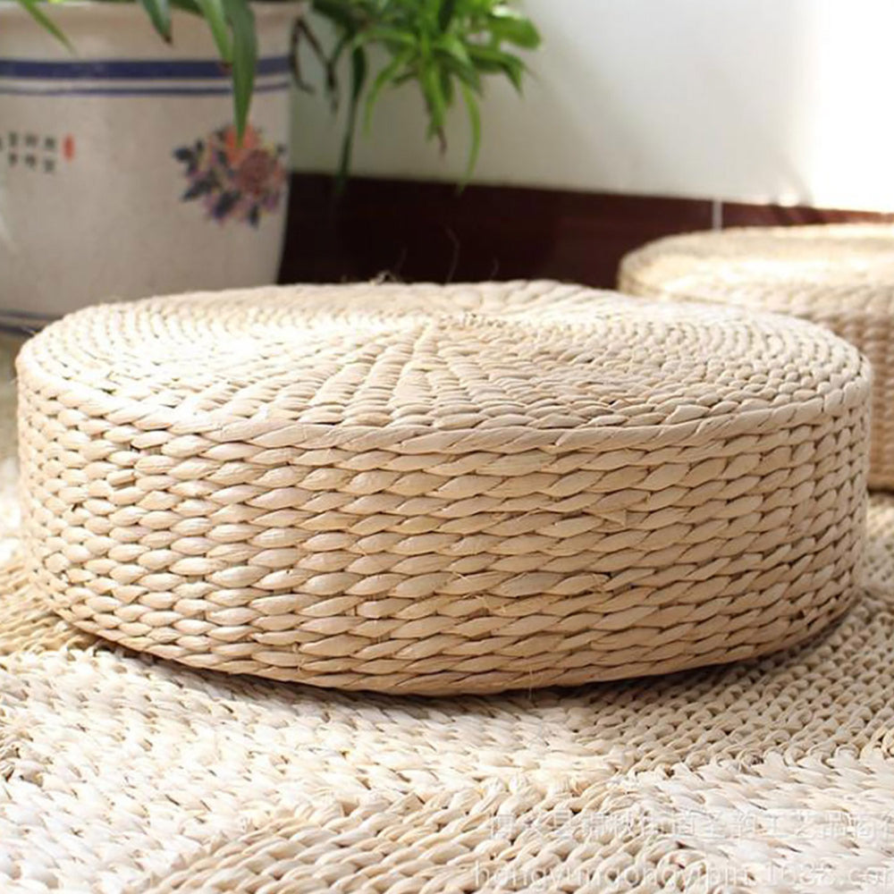 Round hand-braided natural rattan pouf – shown in a room setting (2)