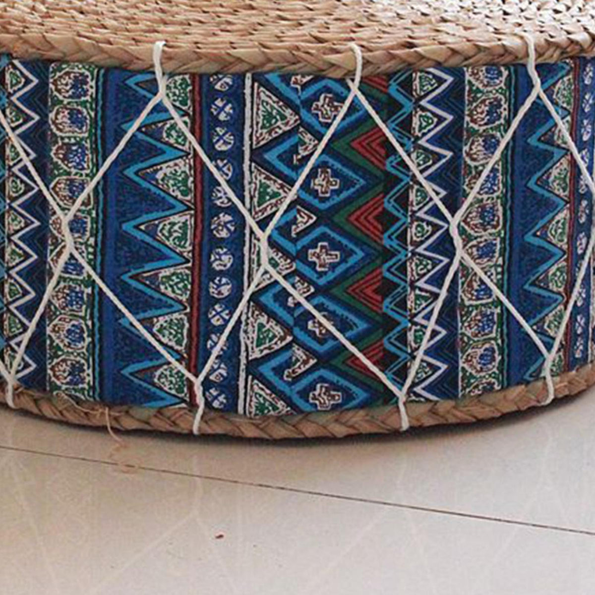 Round woven pouf with a blue-tone pattern – close-up detail