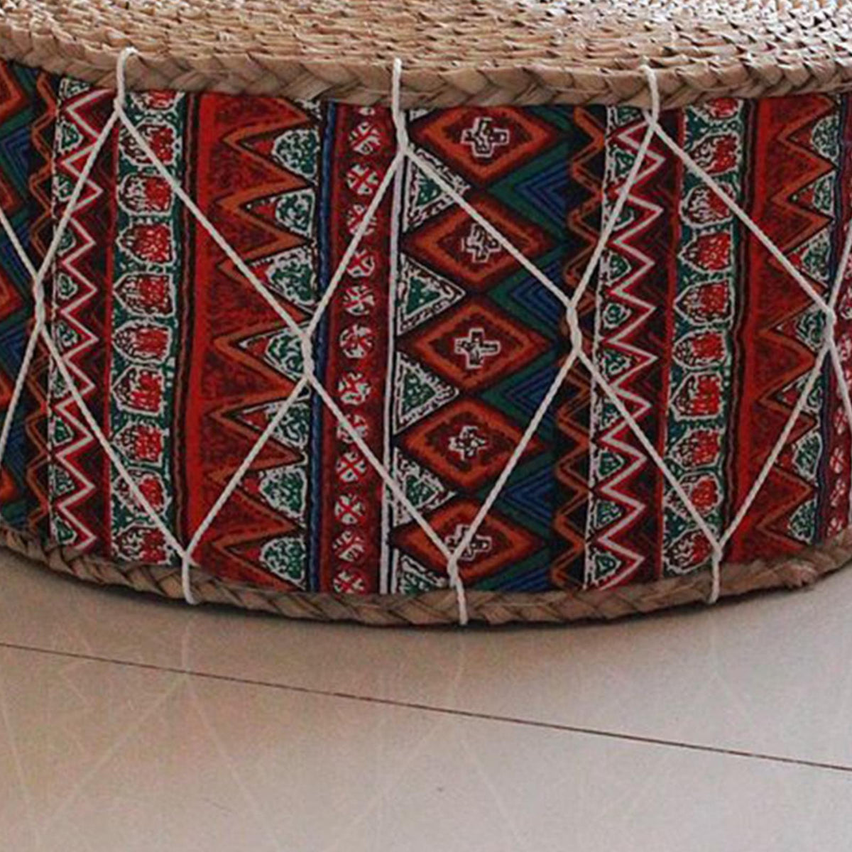 Rattan pouf with burgundy and blue geometric fabric – close-up detail