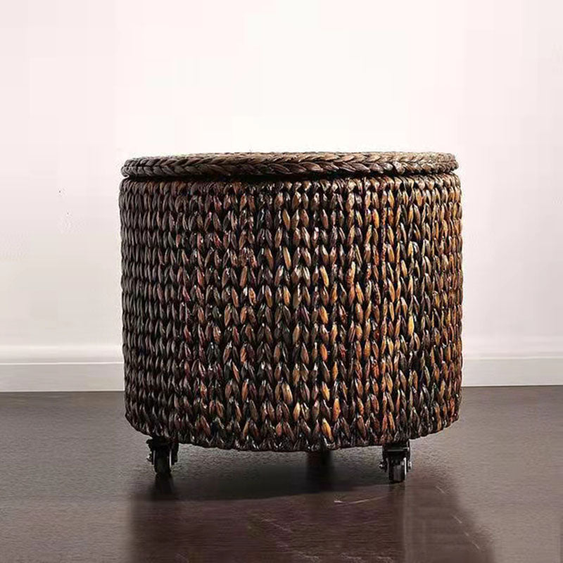 Brown hand-braided rattan footstool on casters with a removable lid