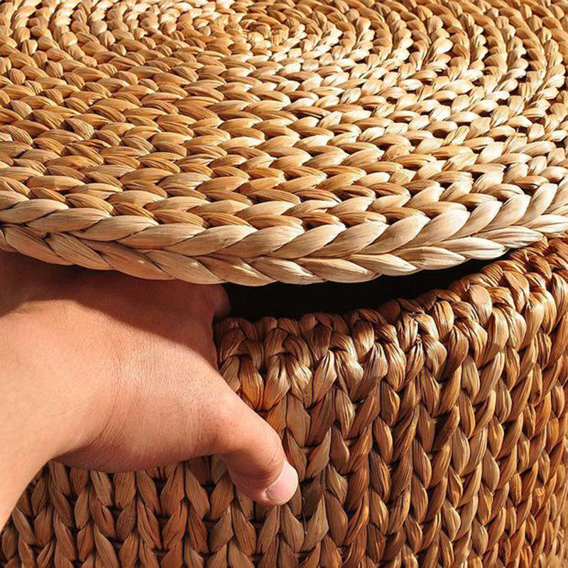 Rattan storage ottoman on casters with a lid – shown in use