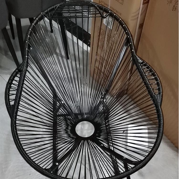 Modern black rattan rocking chair with a hand-braided seat