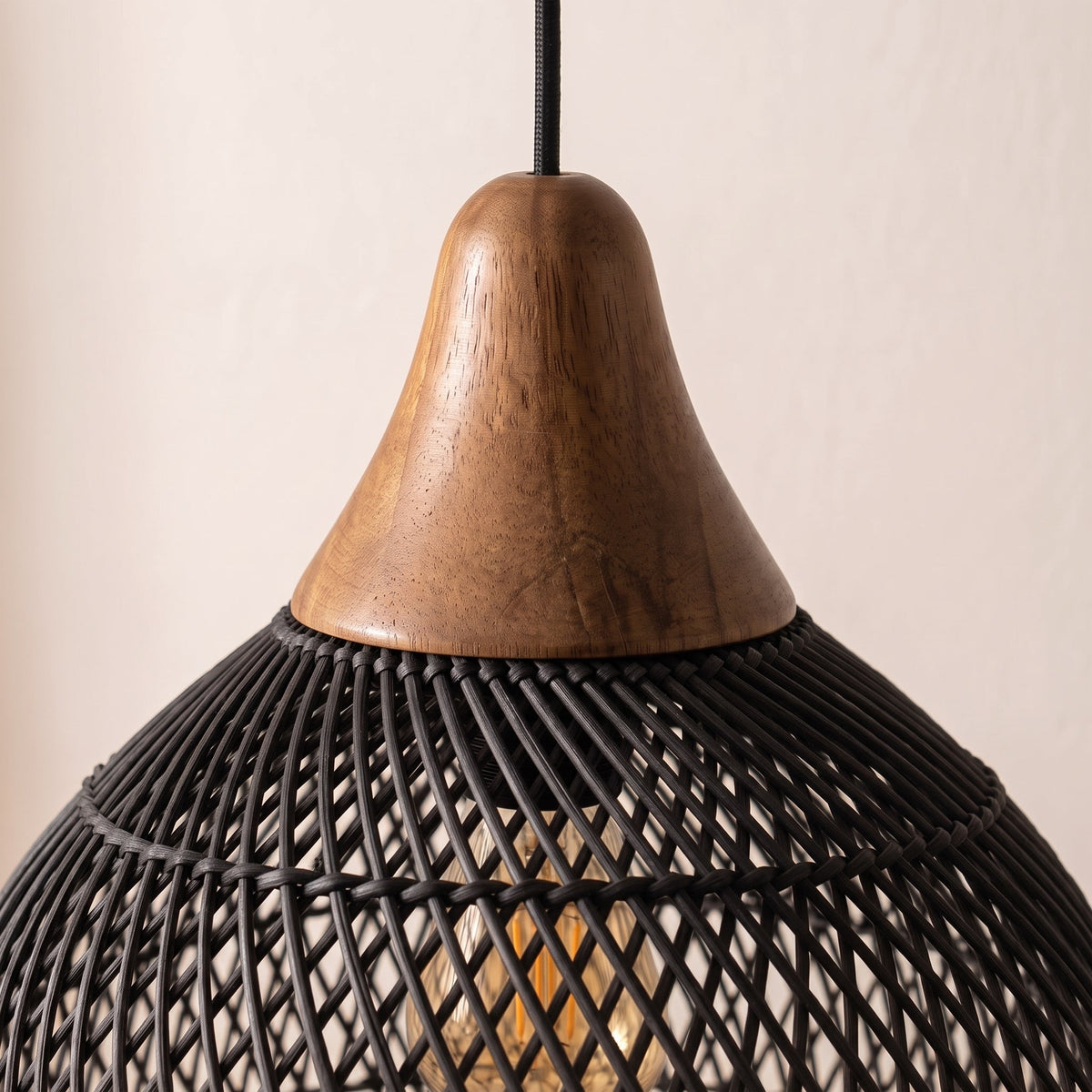 Black rattan pendant light with natural wood cap – close-up detail