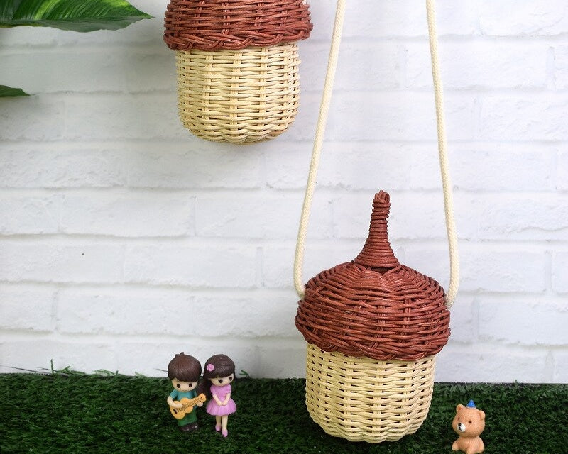 Rounded woven rattan shoulder bag – shown outdoors (2)