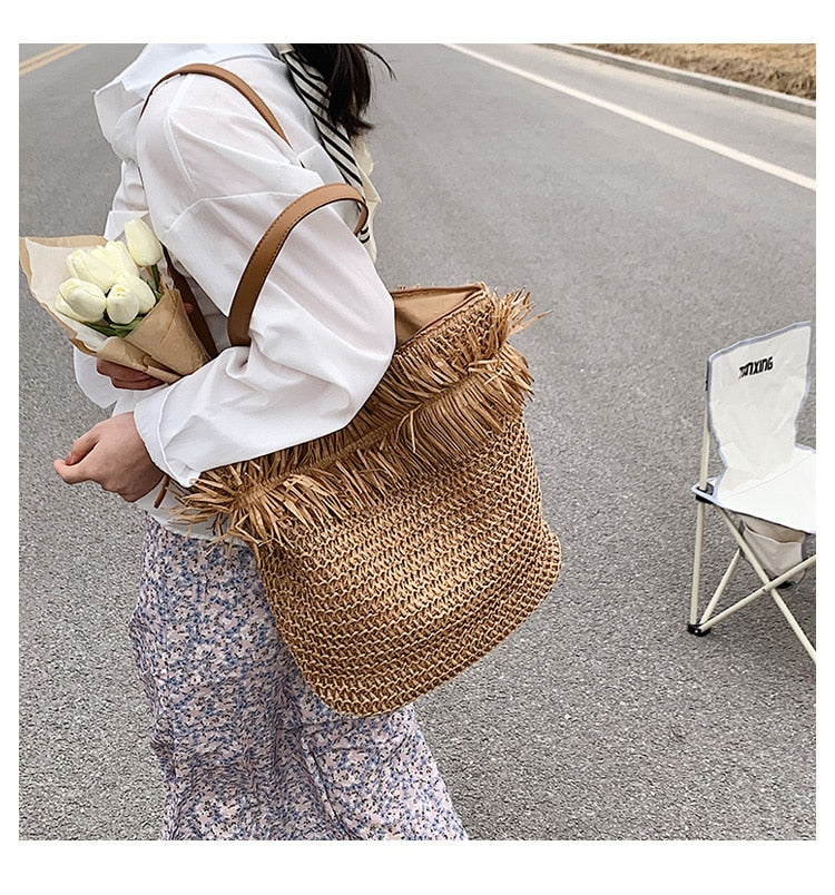 Large white straw crossbody bag with fringe – worn by a model (2)