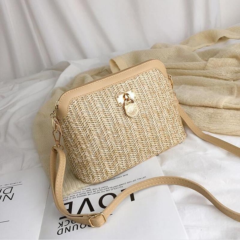 Brown rattan beach bag with a gold chain
