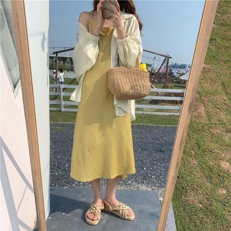 Structured handwoven rattan bag – worn by a model
