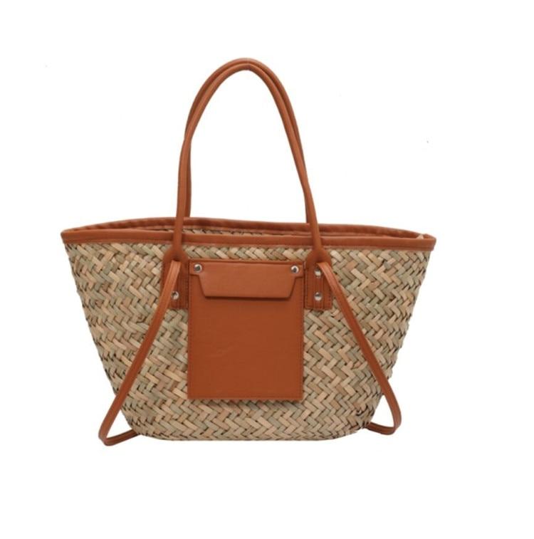 Brown rattan beach tote with a leather handle