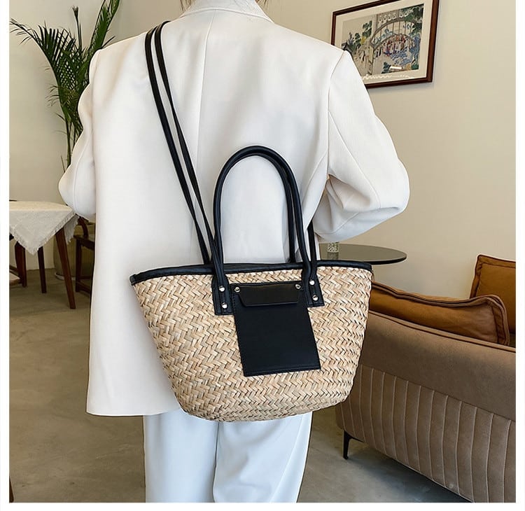 Compact rattan bag with black leather handles – worn by a model (4)